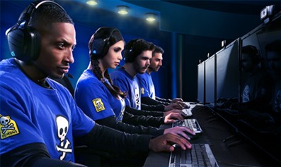Esports team competing at gaming PCs with headsets